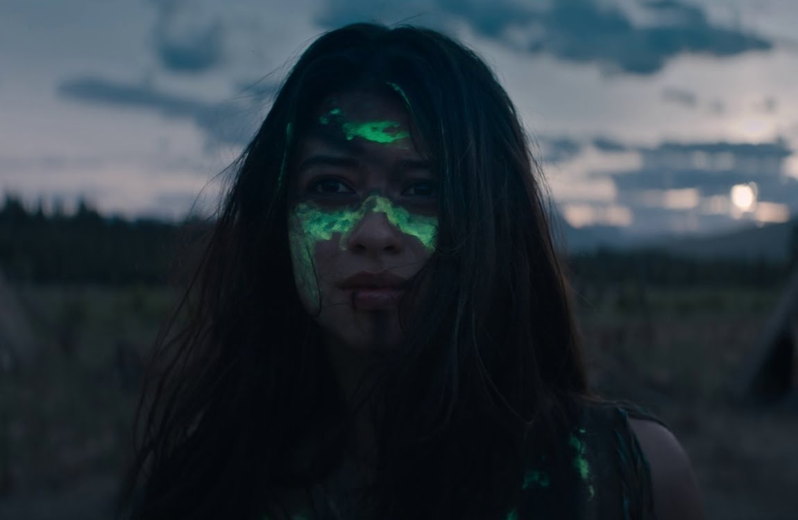 Naru with Predator blood on her face at the end of Prey