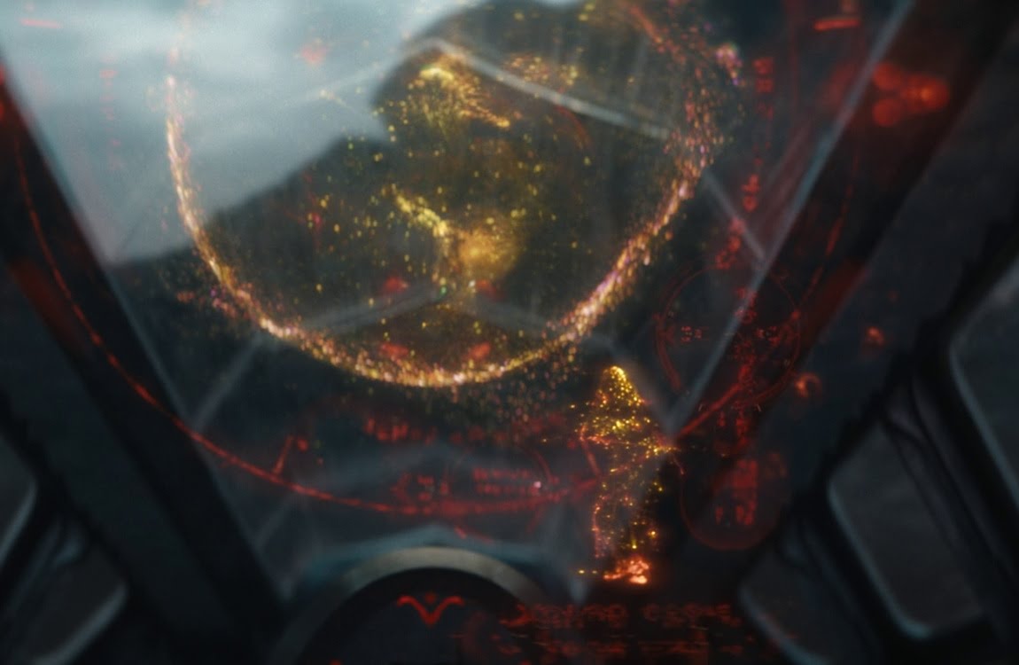 Dek and Kwei viewing the Earth hologram with a projection of Naru from Prey inside Kwei's ship in Predator: Badlands