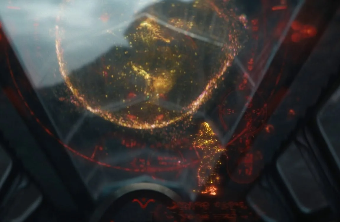 Dek and Kwei viewing the Earth hologram with a projection of Naru from Prey inside Kwei's ship in Predator: Badlands