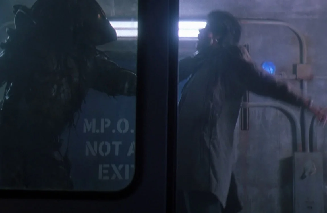 The City Hunter Predator examines Leona in Predator 2
