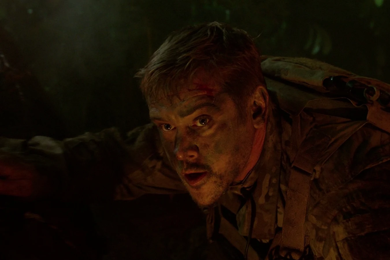 Quinn McKenna beside the crashed fugitive pod, looking up at the cloaked hunter in the trees