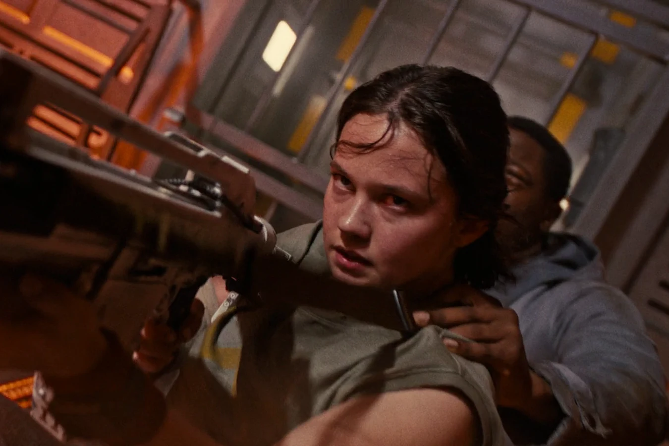 Rain Carradine aims an F44AA Pulse Rifle as Andy steadies her