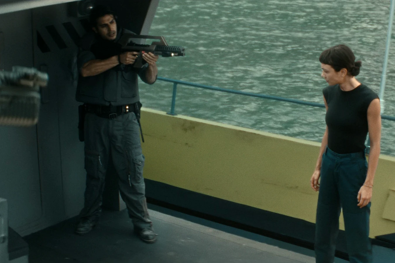 Rashidi aiming his rifle on the deck of a boat at the Neverland dock in Alien: Earth