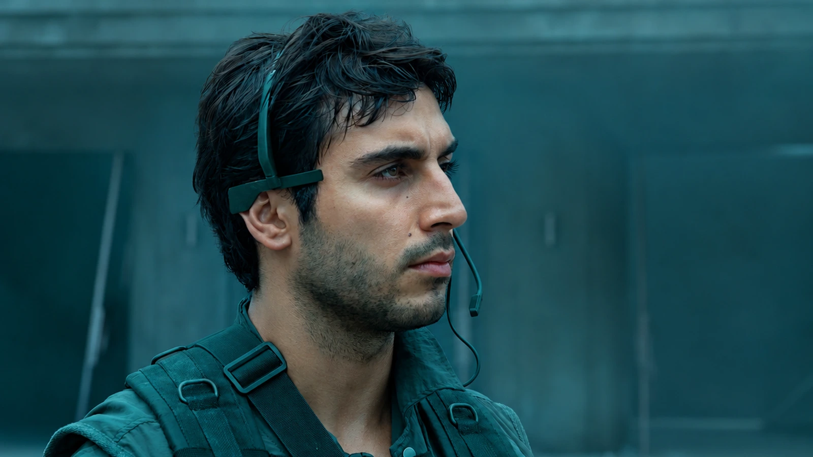 Sergeant Rashidi in his tactical vest and headset microphone, looking to the side in Alien: Earth