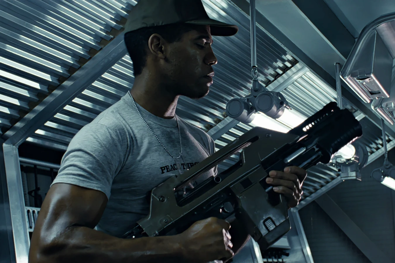 Frost checking an M41A Pulse Rifle aboard the Sulaco in a PEACE THROUGH SUPERIOR FIREPOWER T-shirt