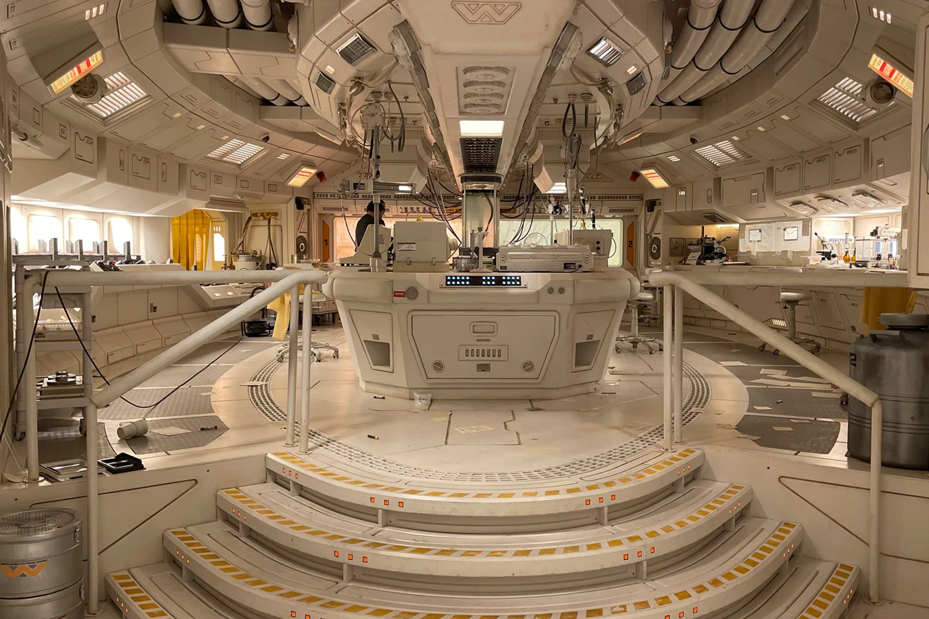 The practical Romulus Lab set from Alien: Romulus, with its oval floor, central fridge, and studio lighting