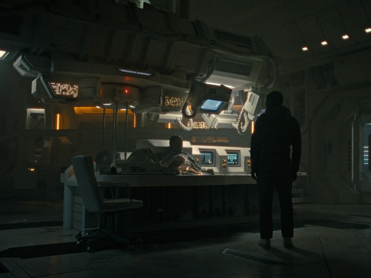 Andy stands over Rook at the Renaissance console