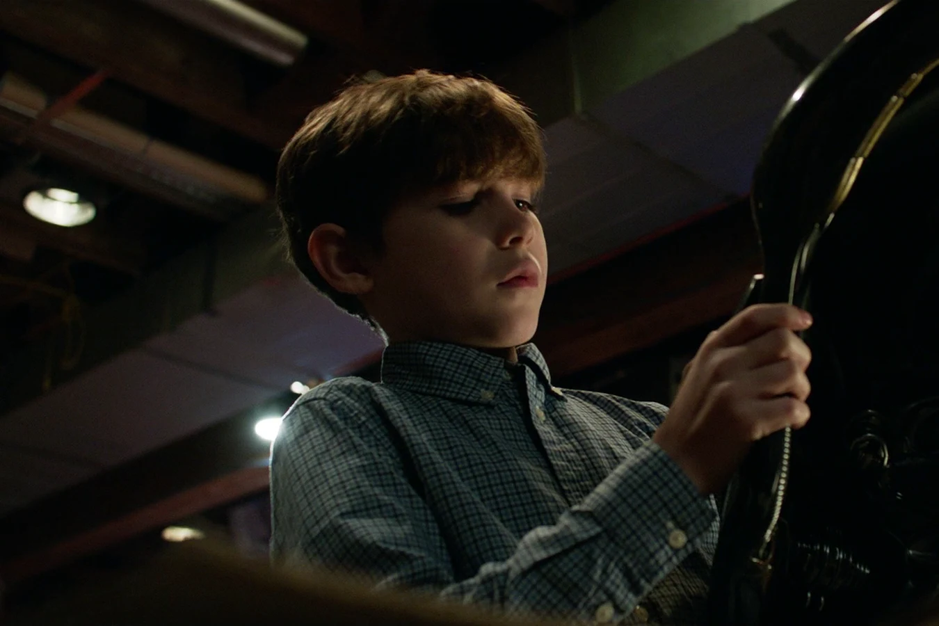 Rory McKenna examining alien technology from the mailed Predator package