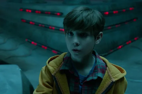 Rory McKenna in a school hallway looking toward the camera during The Predator