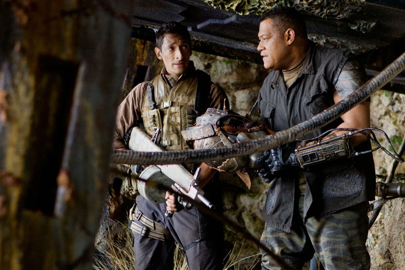 Production still of Adrien Brody as Royce and Laurence Fishburne as Noland inside Noland's hideout