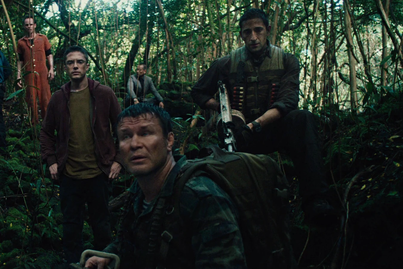 Nikolai, Edwin, Stans, and Royce gathered among the trees and ferns of a dark jungle