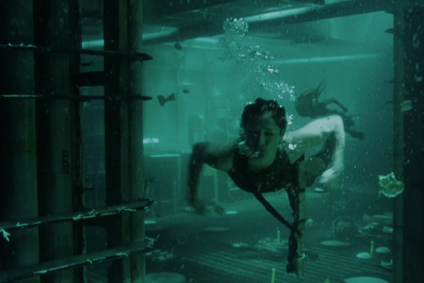 Hillard swimming underwater through the flooded Auriga galley