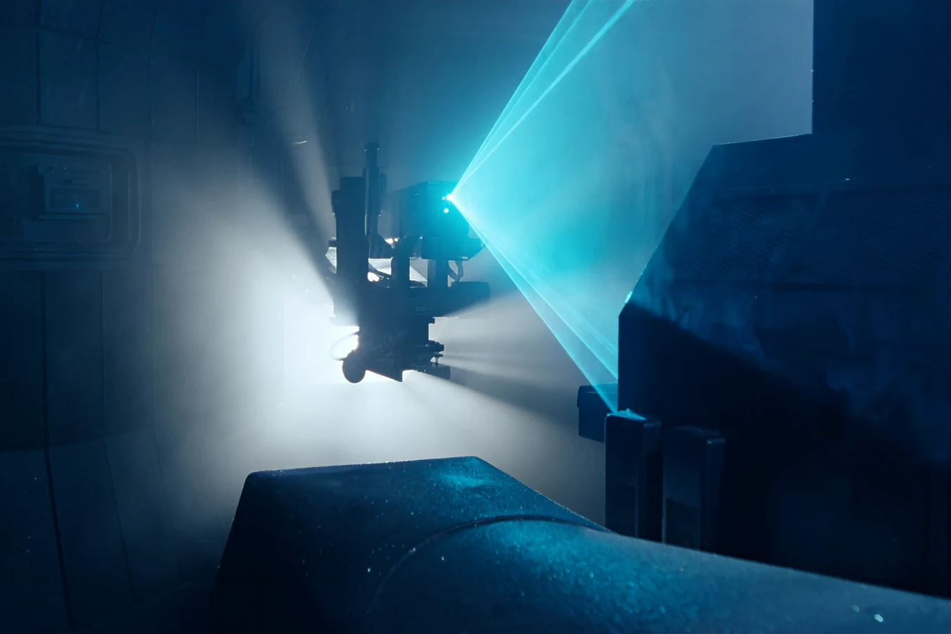 The salvage scanner robot entering the Narcissus with blue laser beams