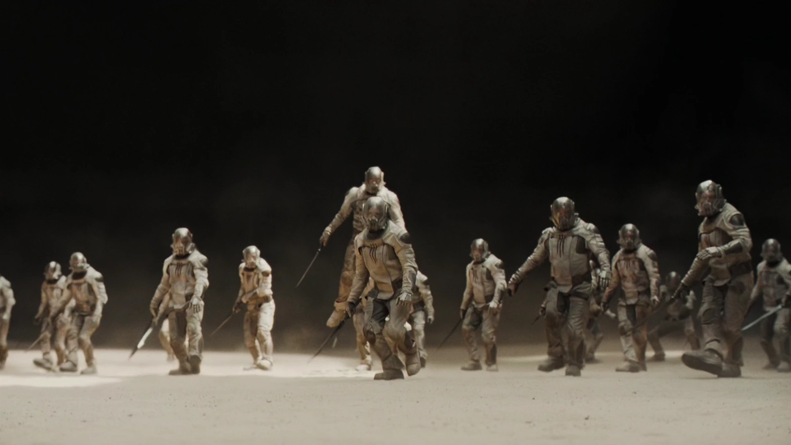 Sardaukar soldiers advancing across sand under a black sky