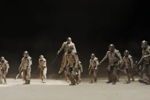 Sardaukar soldiers advancing across sand under a black sky