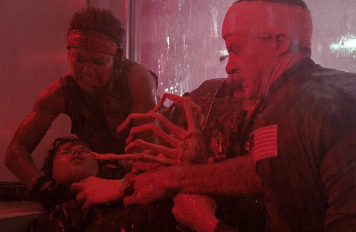Gorman, Hicks, and Vasquez pulling a Facehugger off Ripley in the Hadley's Hope medlab in Aliens