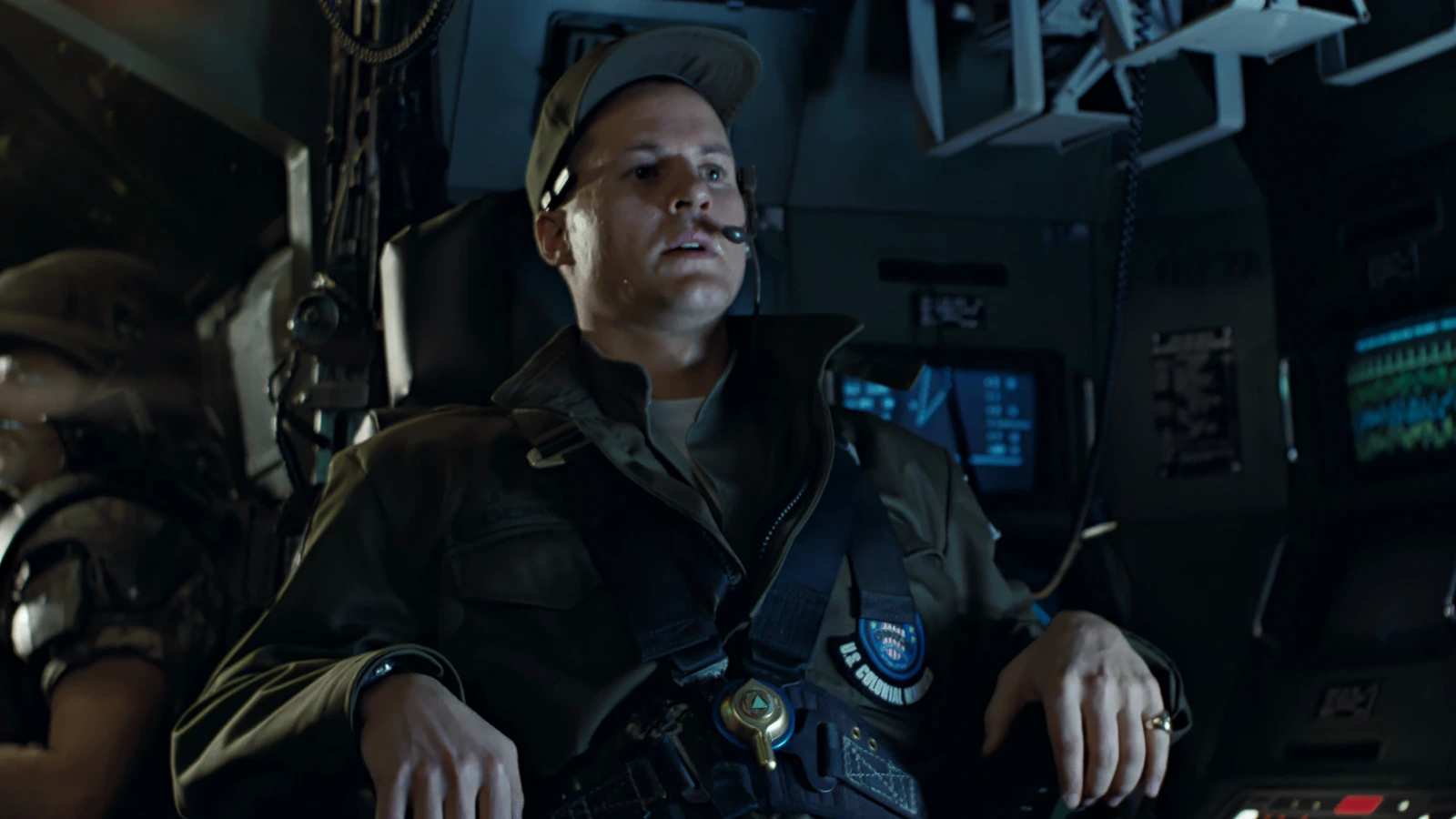 Lieutenant Scott Gorman in a Colonial Marines cap and headset at the APC console in Aliens