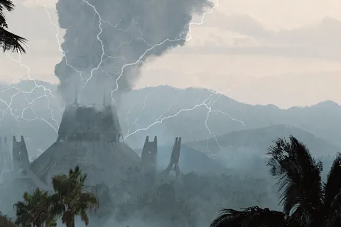 A smoking industrial tower in the rainforest on Shānmén during a lightning storm