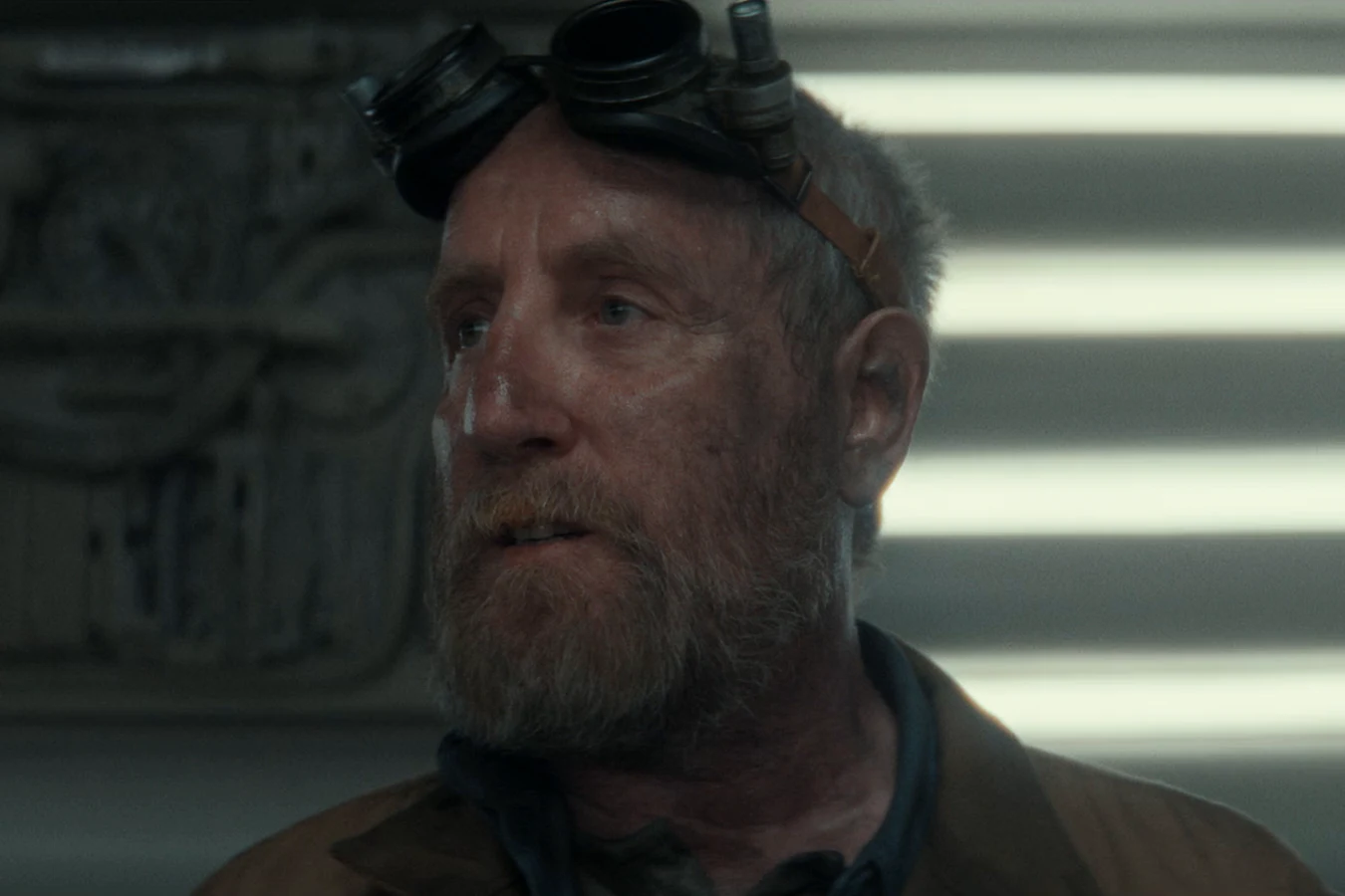 Shmuel with goggles on his head in a lit Maginot corridor in Alien: Earth In Space, No One...