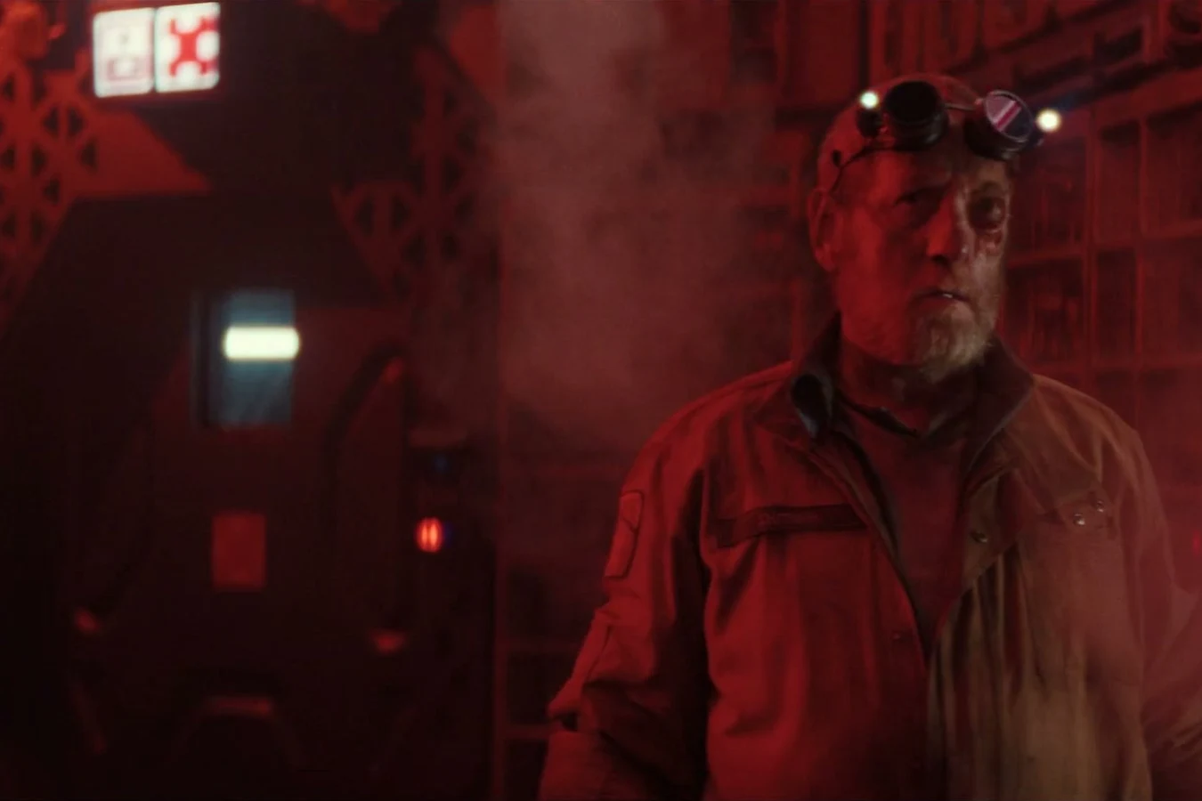 Shmuel under red emergency light with a damaged left eye after T. Ocellus took his body in Alien: Earth