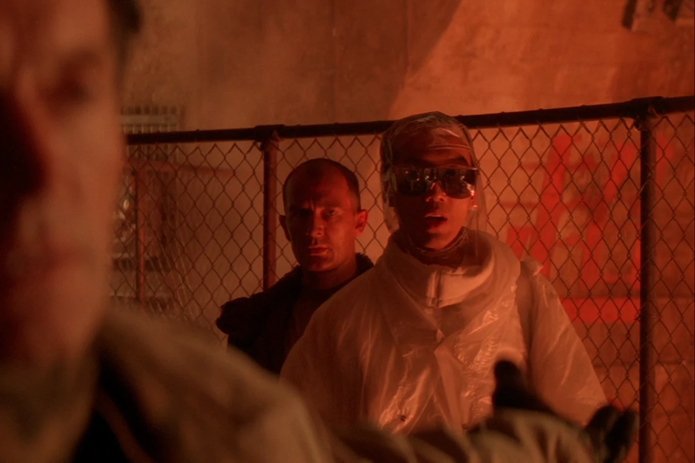 Sora Matsushita in a sealed suit speaking to Ellen Ripley across the furnace fence in Alien 3