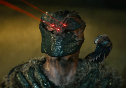 Dek Predator using the Spray Snake as an organic shoulder cannon in Predator: Badlands