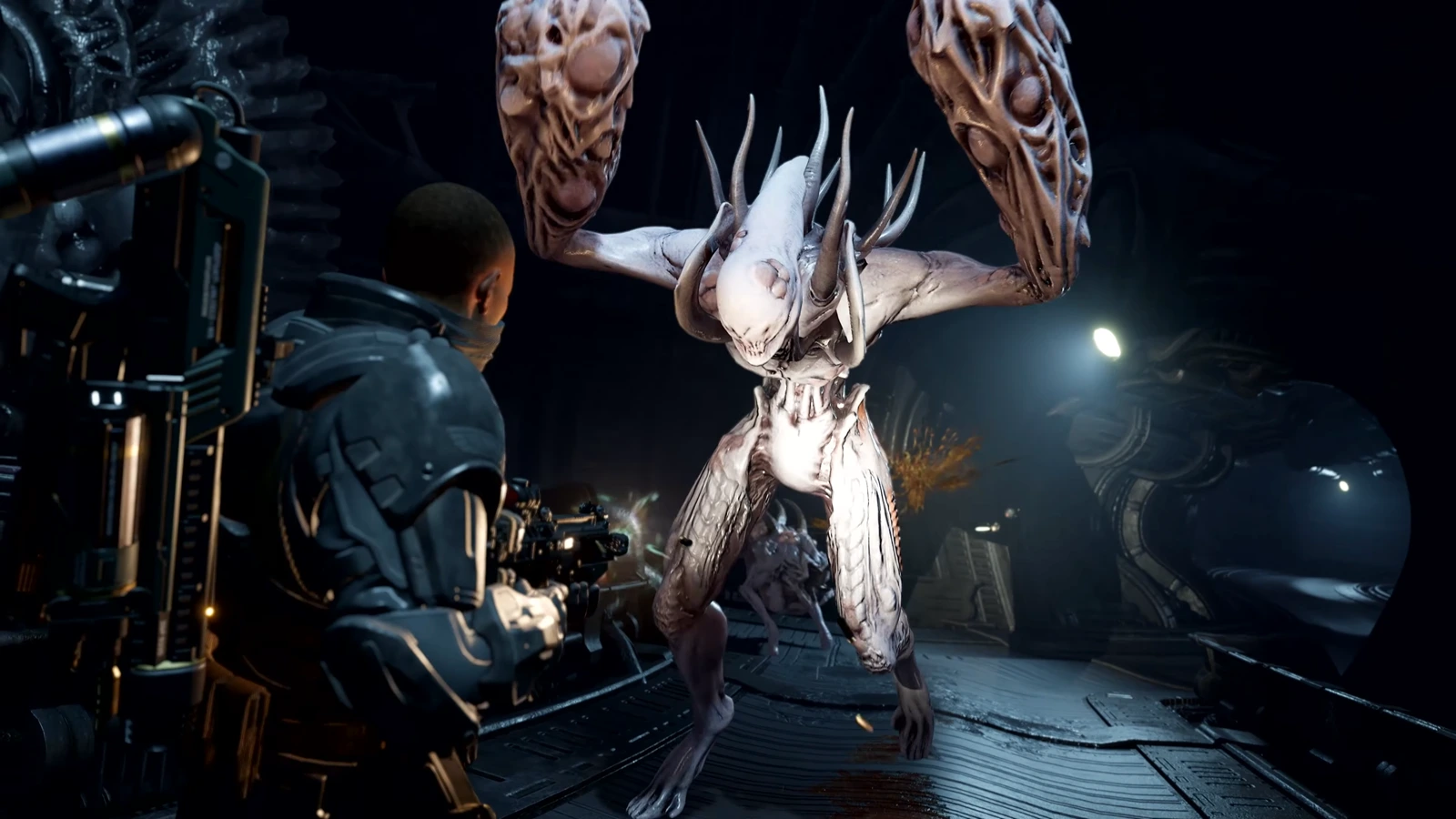 A Colonial Marine firing on a Striker pathogen creature in a dark corridor in Aliens Fireteam Elite 2
