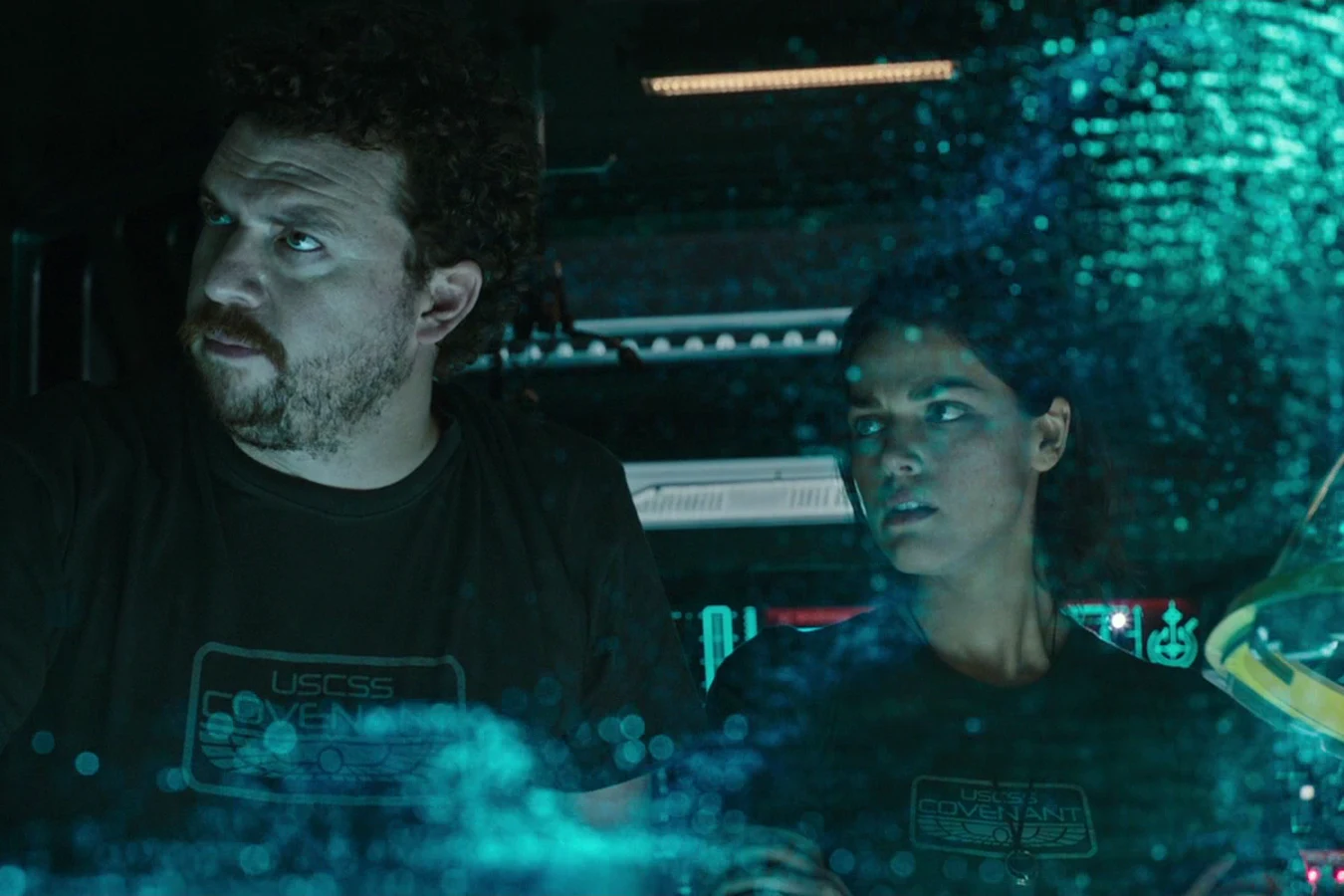Tennessee and a crewmate looking up at a holographic display on the bridge