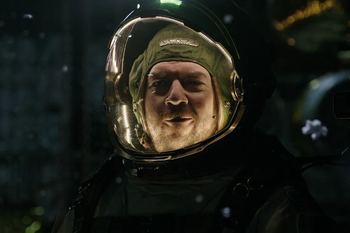 Tennessee smiling inside a gold-lit space helmet
