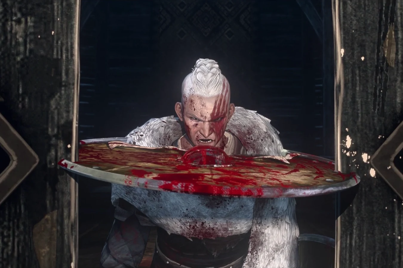 Ursa forces a blood-covered shield through the door of Zoran's fortress