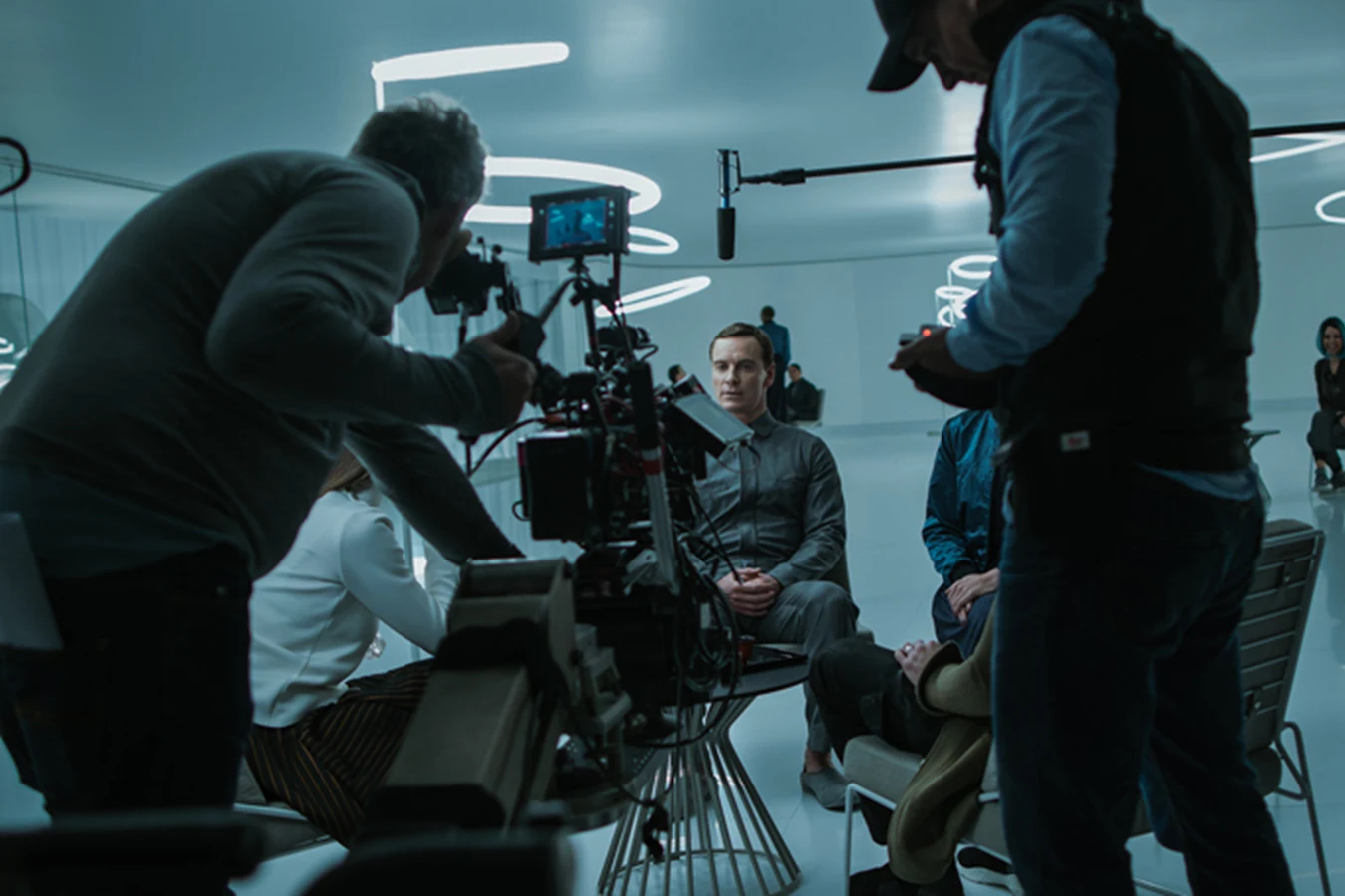 Michael Fassbender as Walter on the white-room set of Alien: Covenant while the camera crew films