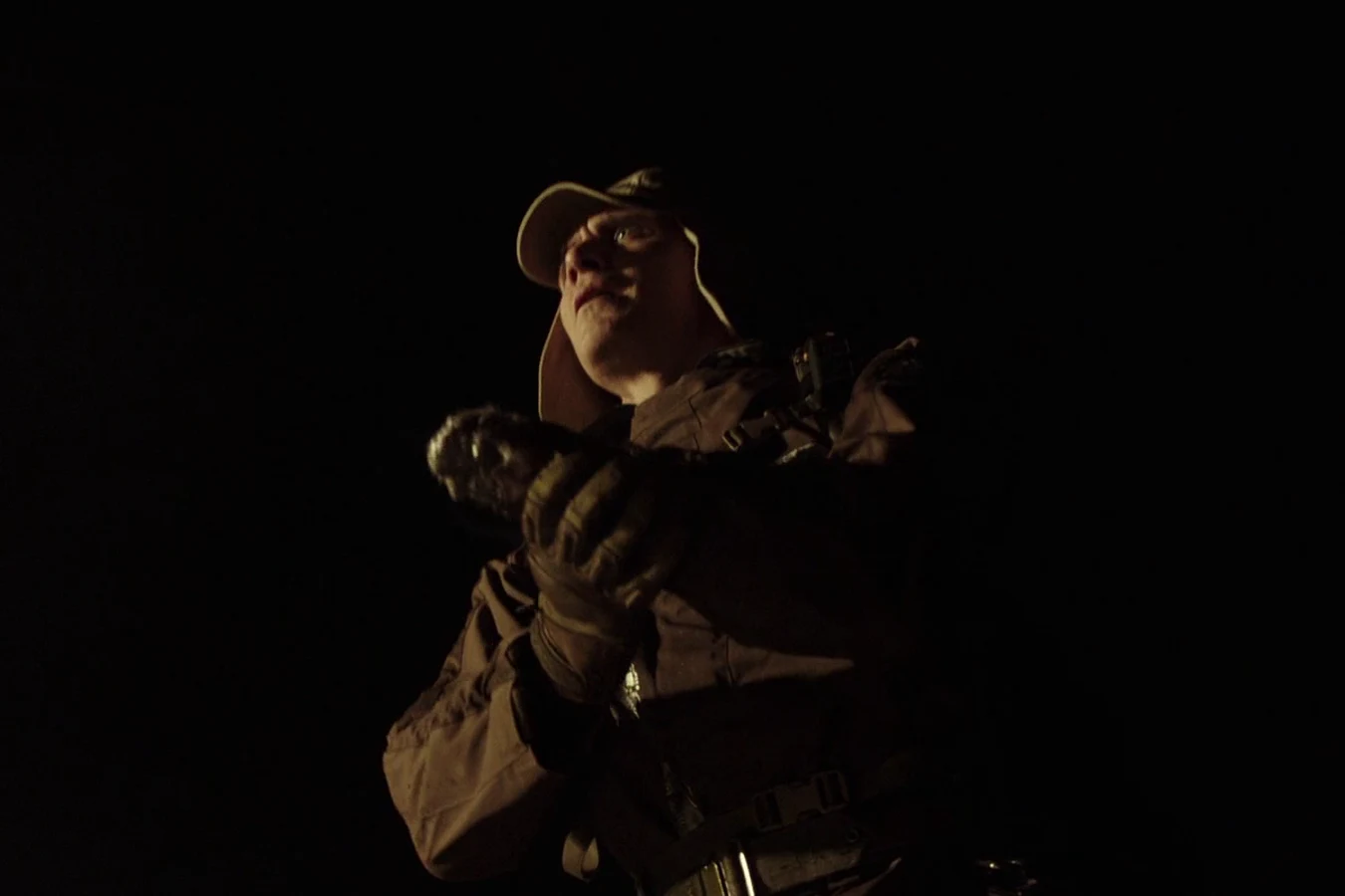 Walter looking at his damaged hand after the Neomorph attack in the wheat