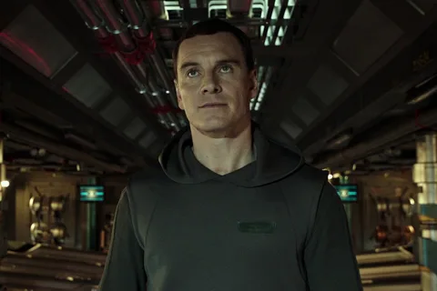 Walter in a hooded suit in a corridor of the USCSS Covenant