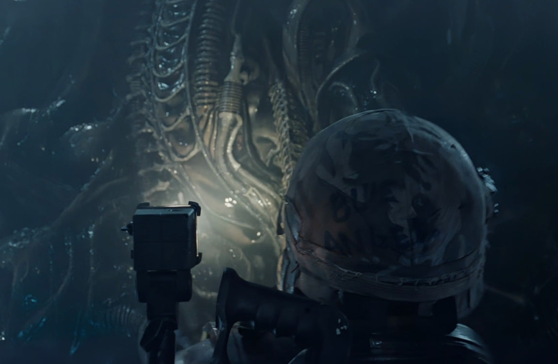 A Xenomorph blends into the hive wall while Dietrich watches