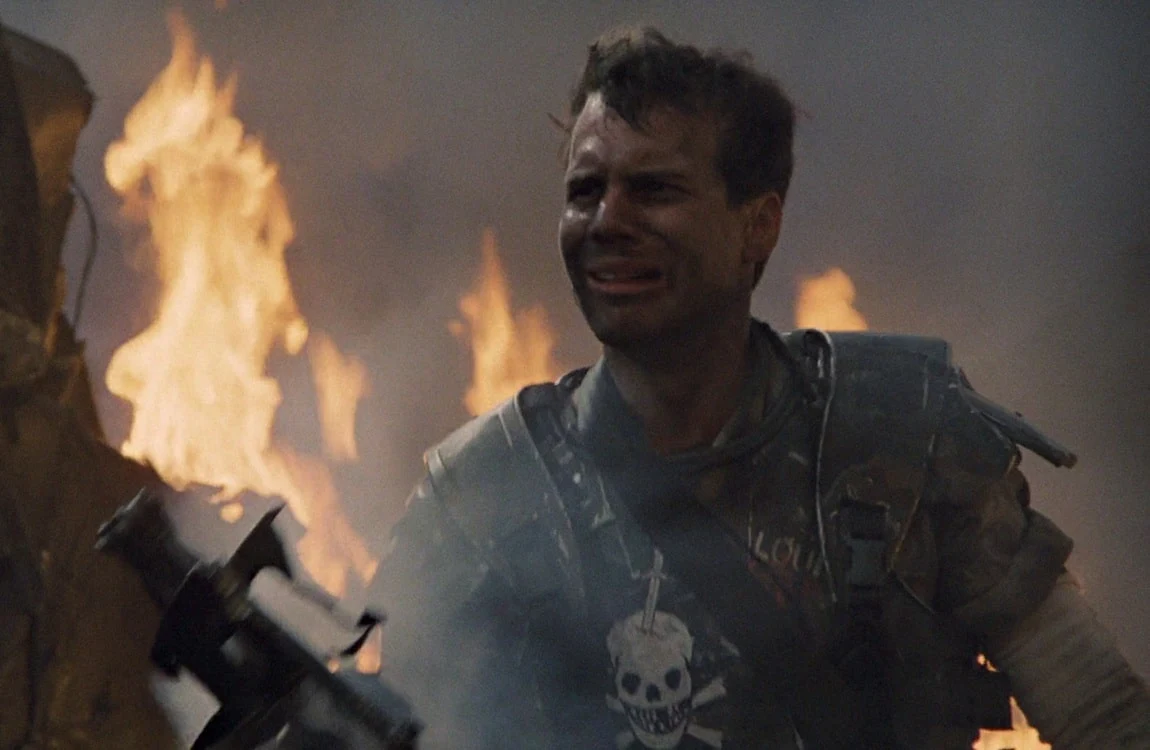 Hudson staring at the burning dropship wreckage after the escape from the atmosphere processor in Aliens