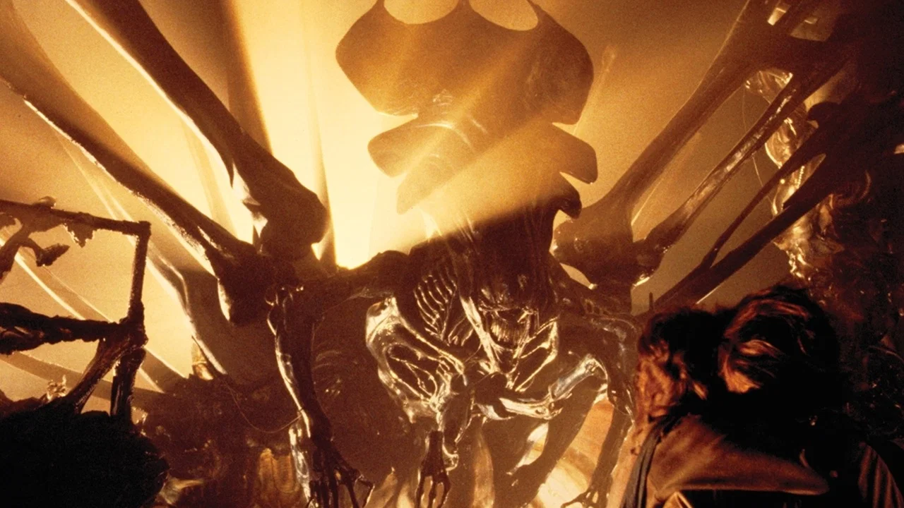 Ripley confronting the Xenomorph Queen in her egg chamber.