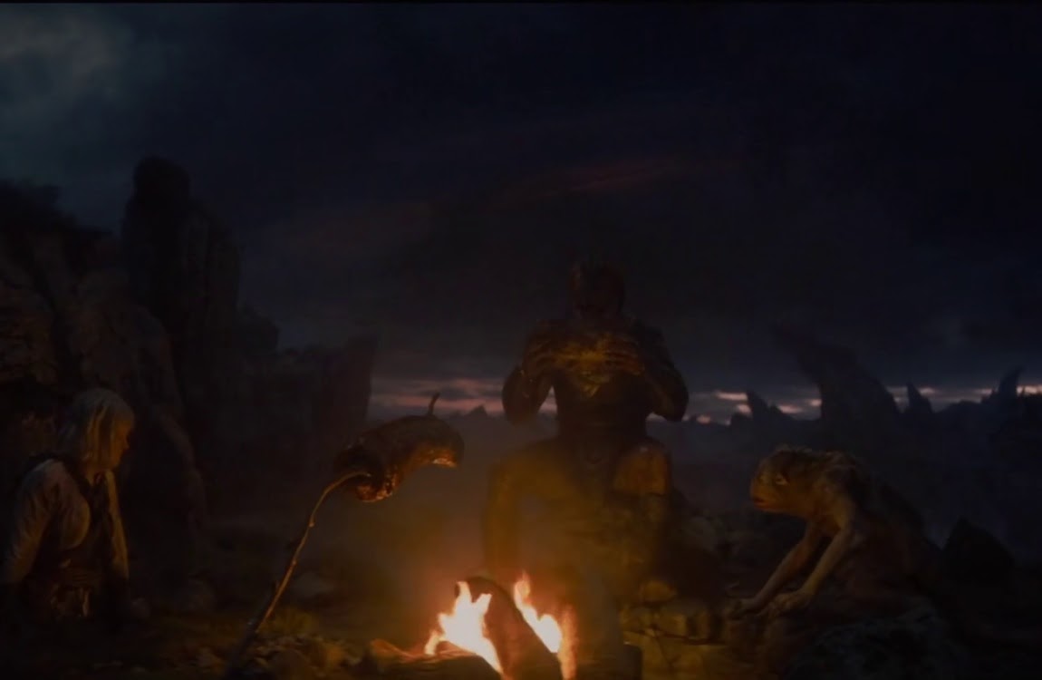 Dek Predator barbecuing meat with Bud and Thia in Predator: Badlands