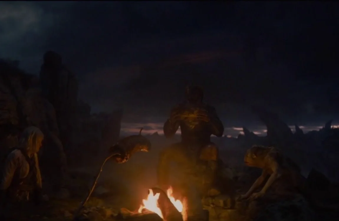 Dek Predator barbecuing meat with Bud and Thia in Predator: Badlands