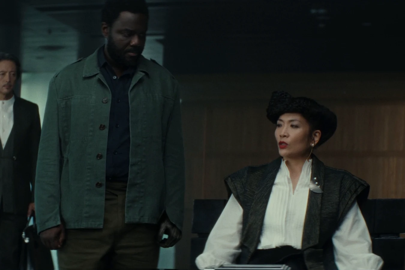 Yutani seated at the arbitration table as Morrow stands nearby after the hearing in Alien: Earth