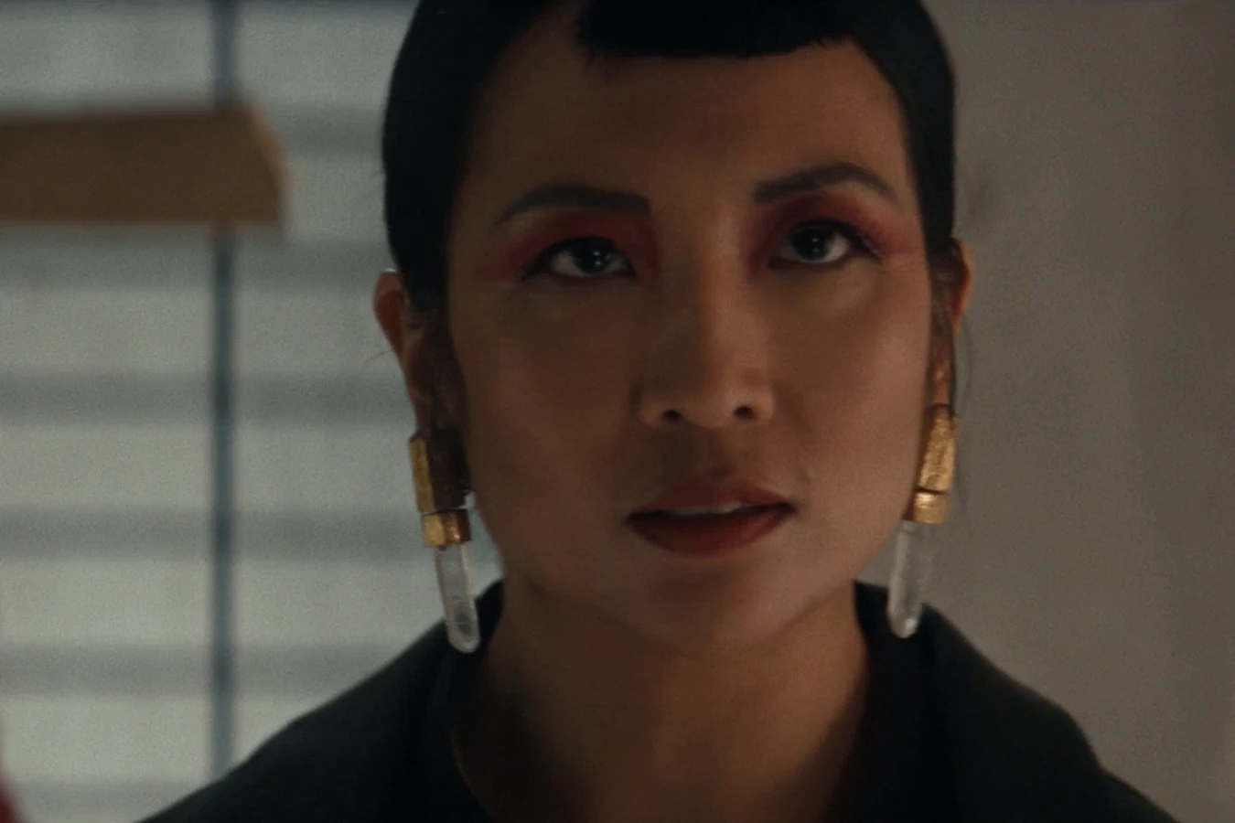 Yutani facing Morrow in her Weyland-Yutani tower with a red-armored guard behind her in Alien: Earth
