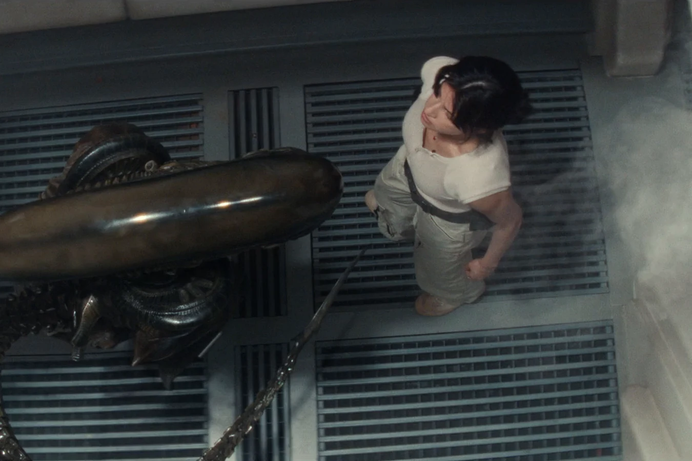 Overhead view of Zoya Zaveri facing a Xenomorph on a Maginot grated walkway in Alien: Earth