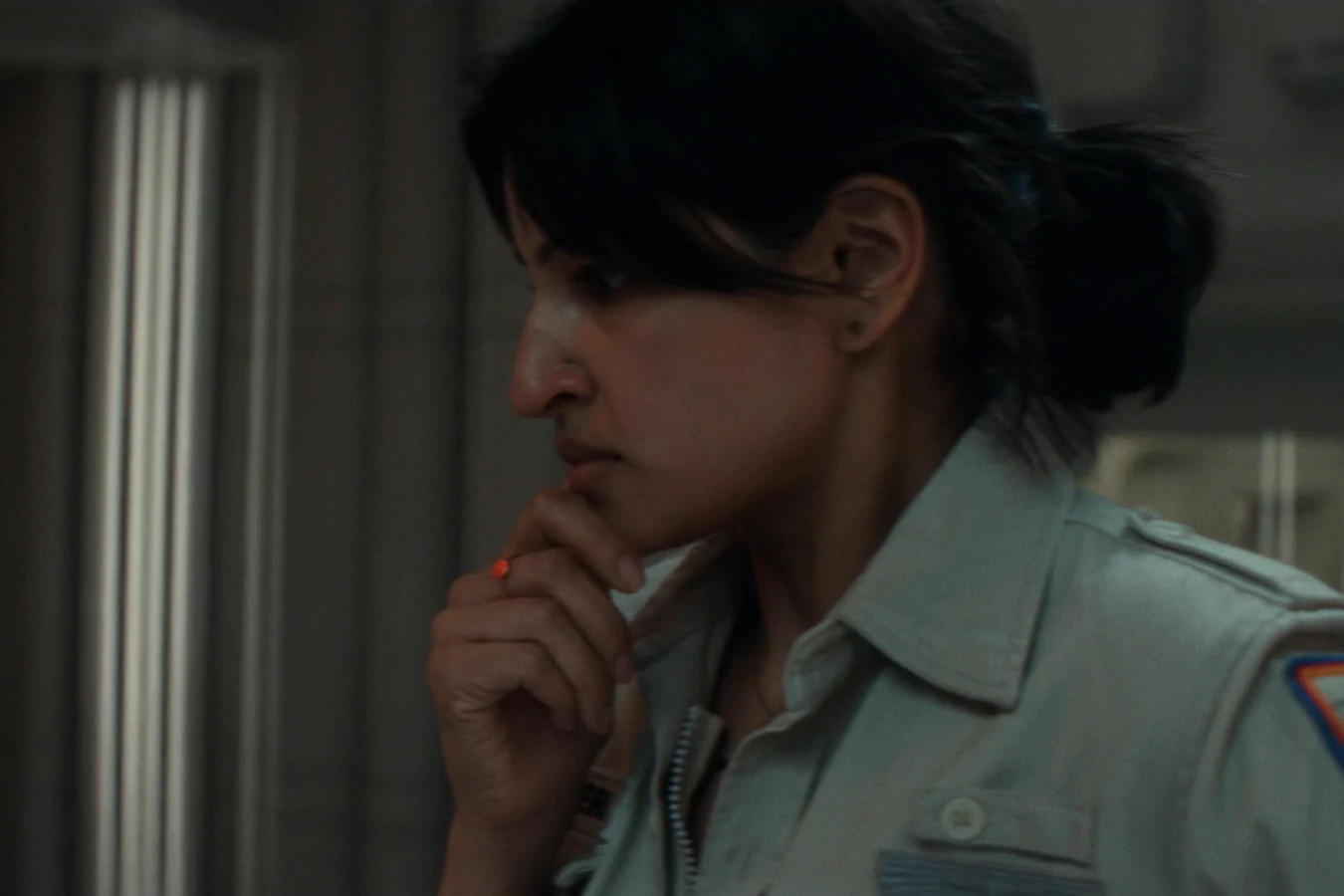 Zoya Zaveri standing thoughtfully in a Maginot corridor after speaking with Mother in Alien: Earth