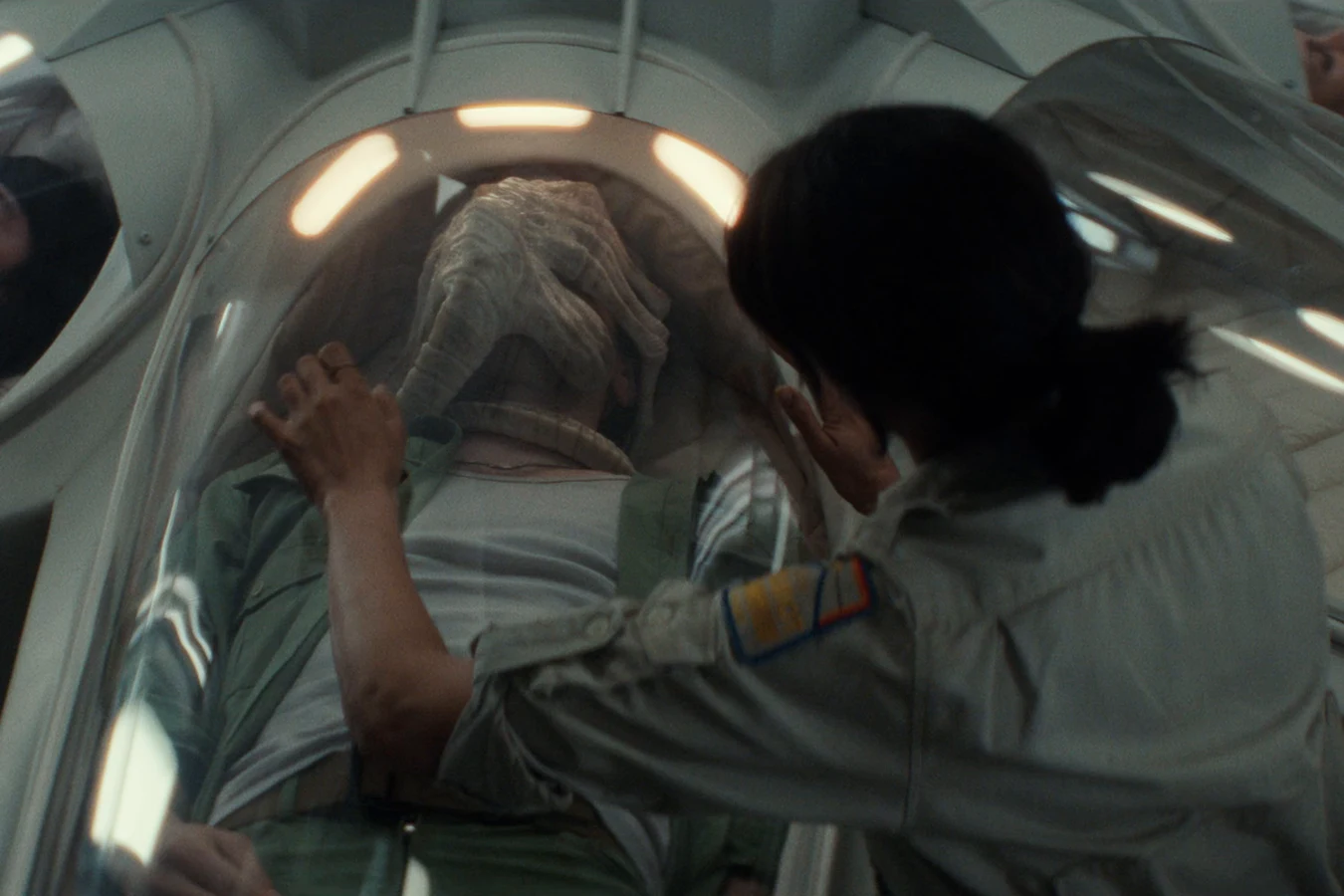 Zoya Zaveri leaning over Bronski's cryopod with a Facehugger still attached in Alien: Earth