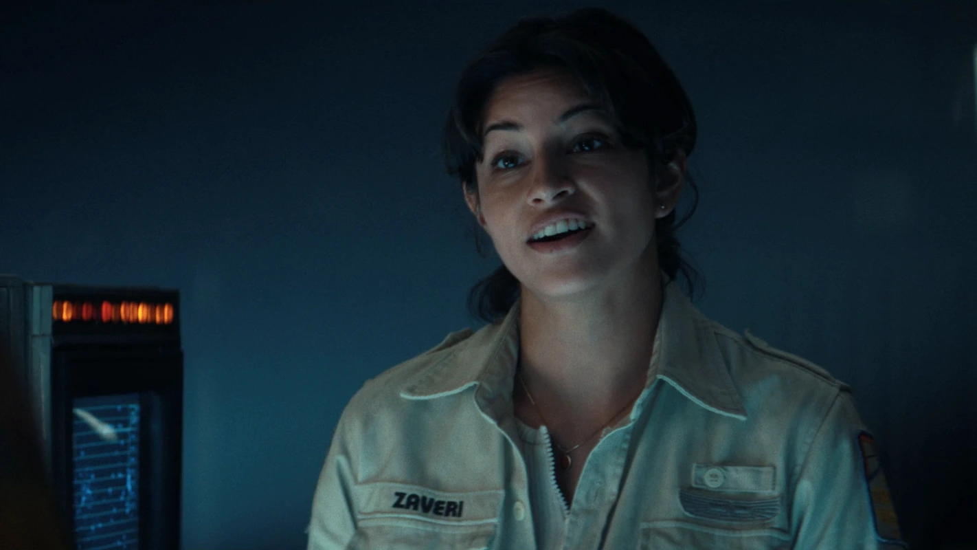 Zoya Zaveri in her Maginot uniform with a ZAVERI name tape, speaking beside a navigation screen in Alien: Earth